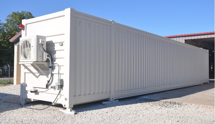 Exterior view of a white 53' Groundhog mobile shooting range container with a large HVAC unit mounted on the front.