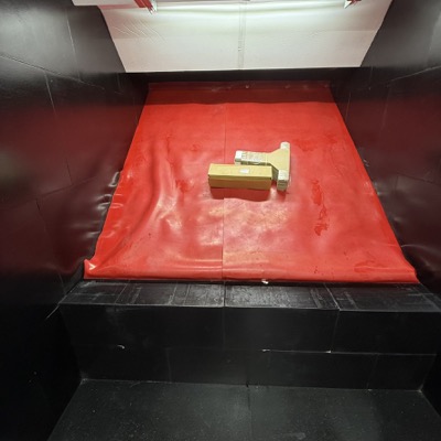 Sloped rubber bullet trap