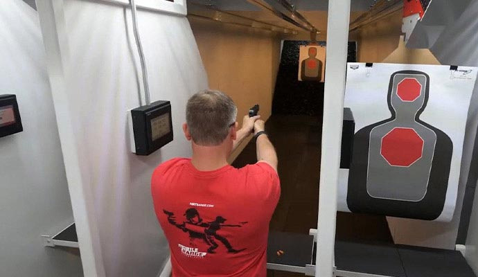 Man shooting in mobile range booth