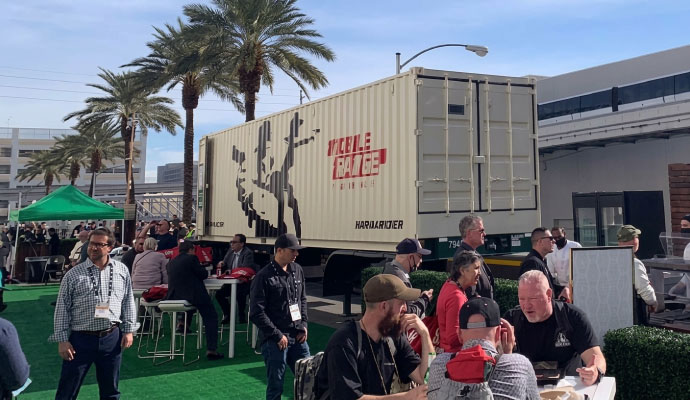 Mobile shooting range trailer exhibited at commercial outdoor event for gun store owners