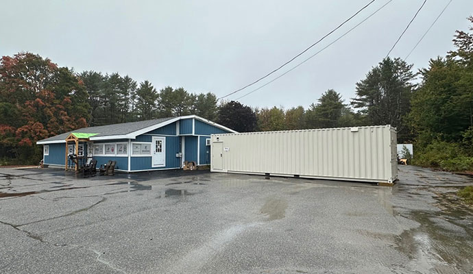 Modular container shooting range installed outside commercial building
