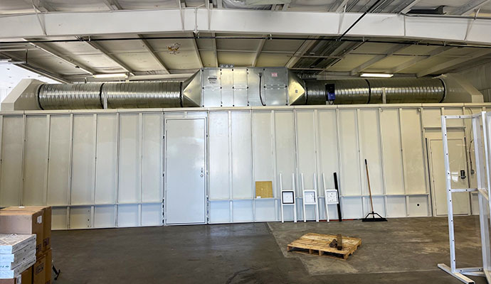 Indoor panelized shooting range installation with overhead ventilation inside a commercial facility