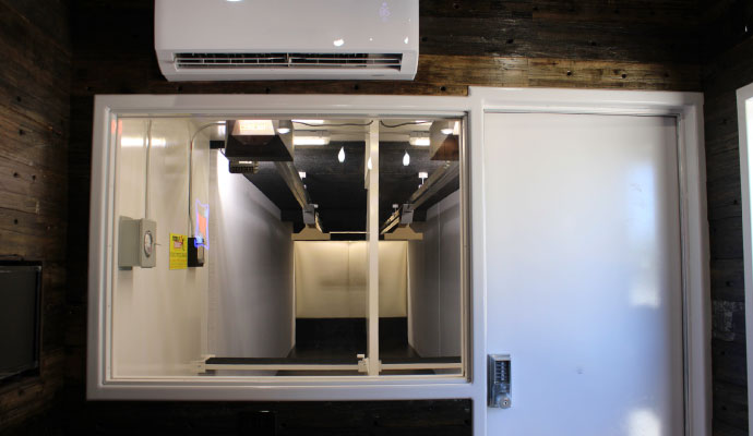 Control room with a ballistic glass window looking into shooting lanes