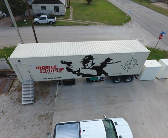 White shipping container featuring black pistol aiming figures