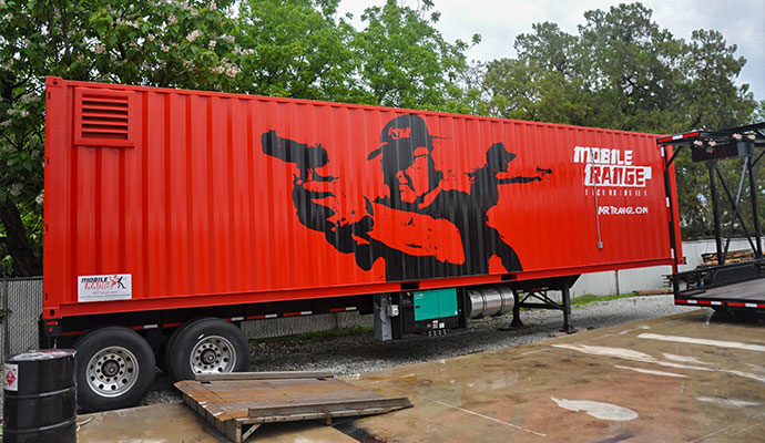 Red mobile shooting range trailer featuring custom shooter graphics