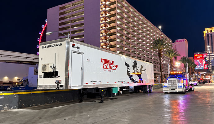 Road King mobile shooting range trailer attached to semi-truck at outdoor event