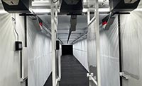A view looking down the length of the interior firing lane of a 25-yard mobile shooting range