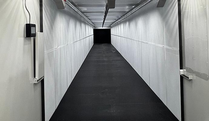 A long, perspective view of a professional indoor firing range