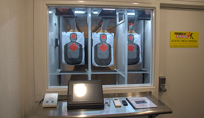 Static rifle range control console desk and target lanes viewed through window